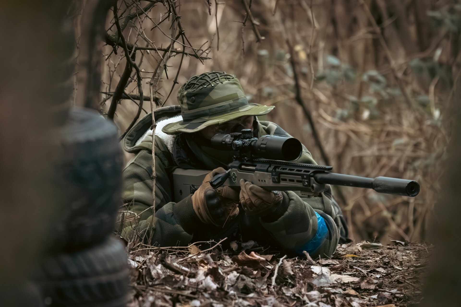 Man holding a rifle in the woods