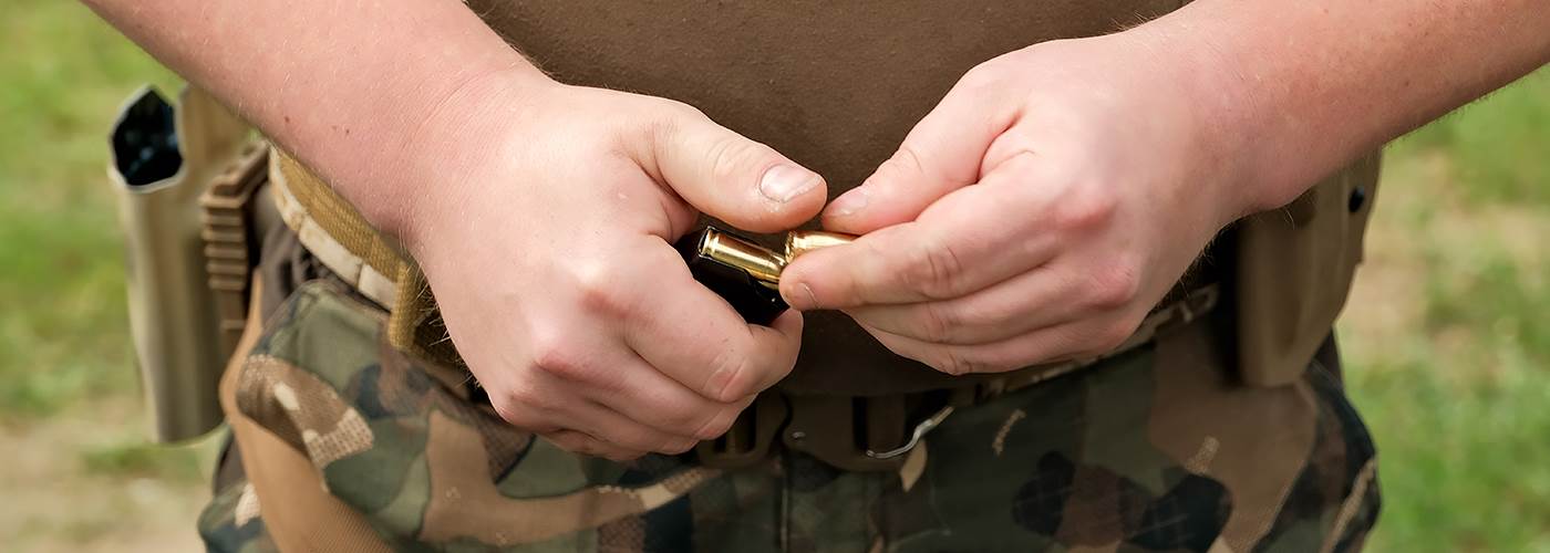 Shooter loading a magazine at the range