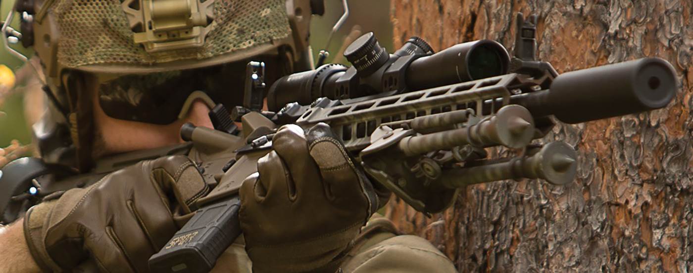 Shooter using canted sights to engage close targets in the wood