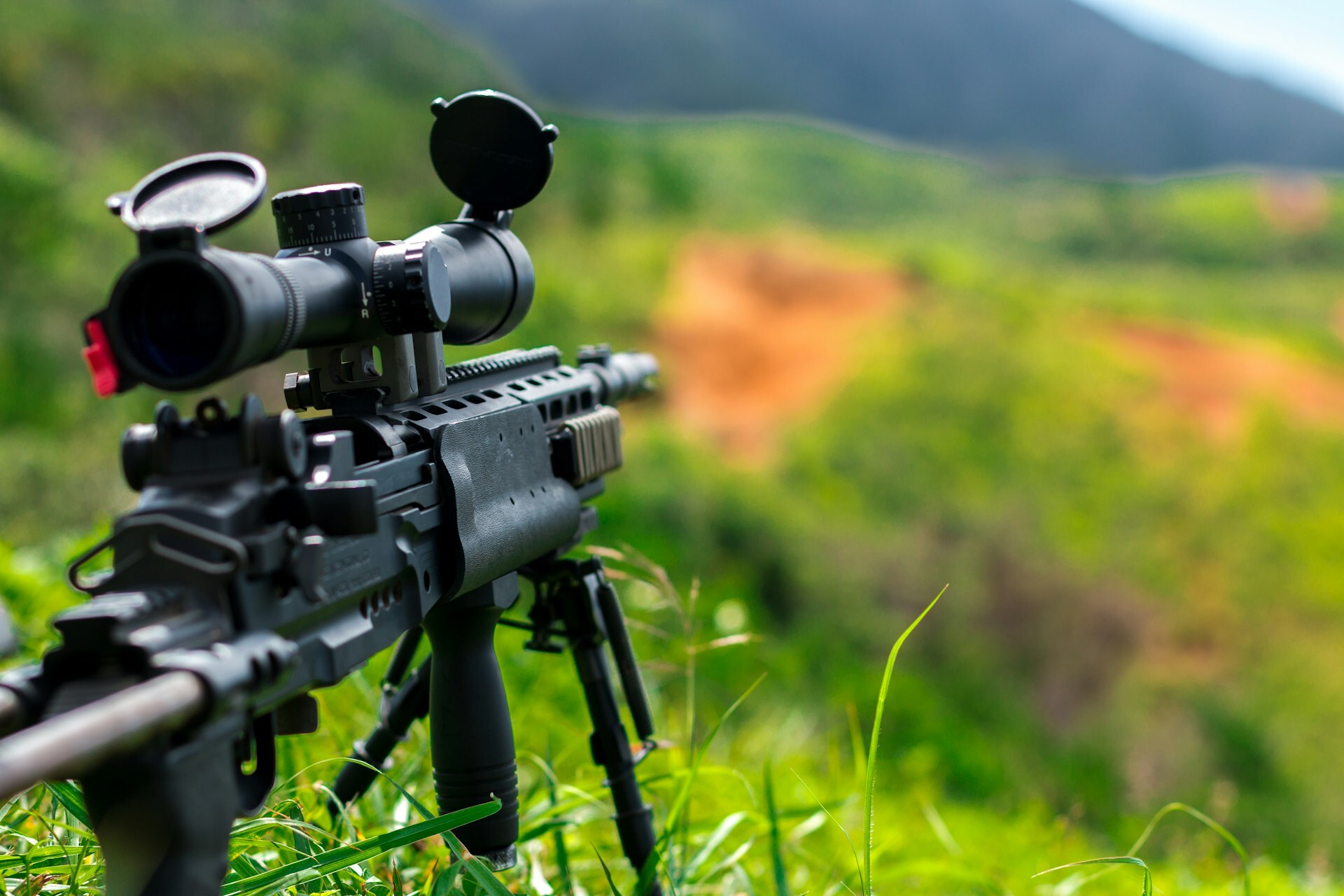 Sniper rifle set up in green grass