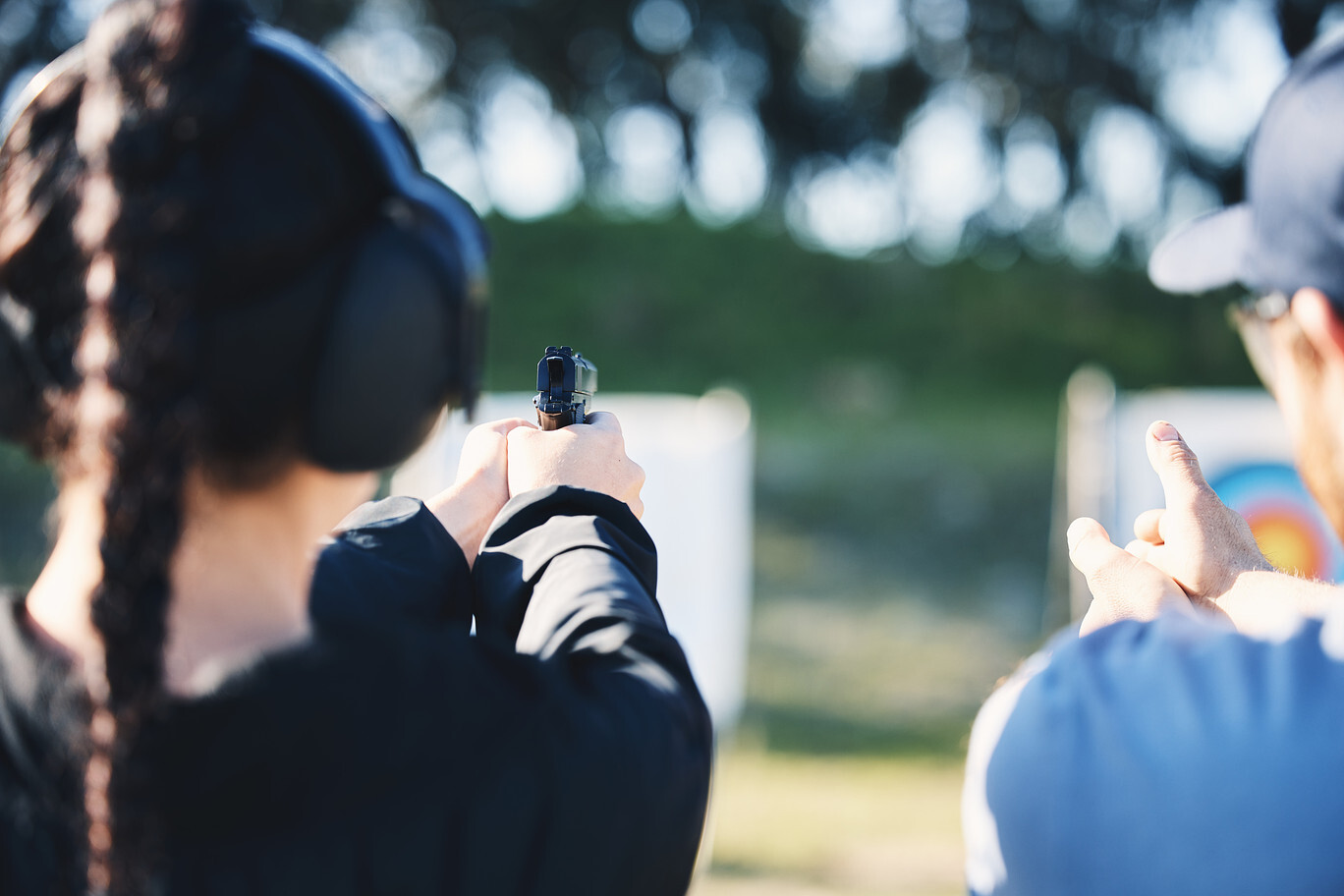 Woman aiming a handgun